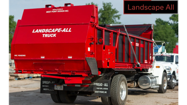 A red Landscape-All truck parked outdoors with a clear blue sky.