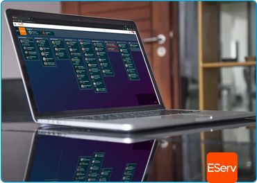Laptop displaying a project management tool with task boards, reflecting on a shiny table.