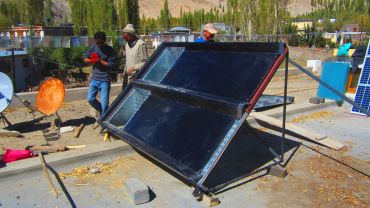 Solar panel setup in an outdoor area with workers.