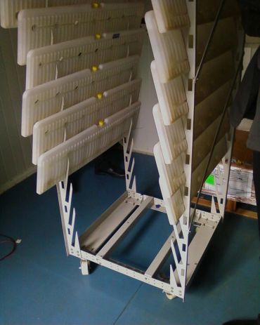 A white metal rack holding multiple fluorescent light tubes.