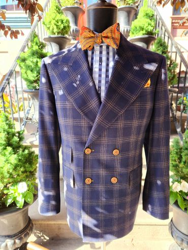 Navy plaid double-breasted—sharp peak lapels, caramel buttons, bold contrast lining, pure confidence