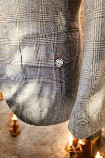 Flap pockets with functional buttonholes and contrast stitching—subtle touches of bespoke precision.