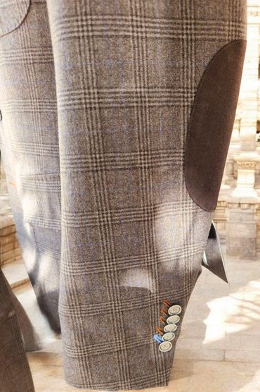 Classic elbow patches and contrast buttonholes offer timeless flair with tailored individuality.