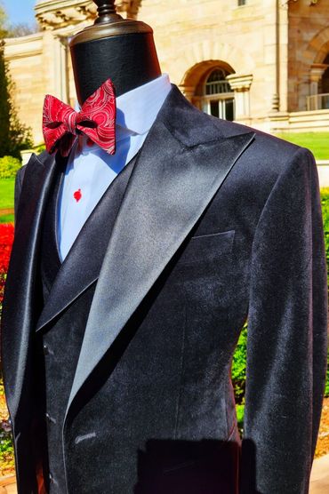 Bespoke three-piece velvet tuxedo with wide satin peak lapels on jacket and vest. 