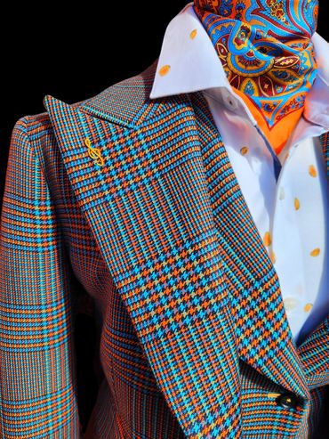 Bold custom houndstooth plaid suit with peak lapels, vibrant tailoring, and luxury bespoke detailing
