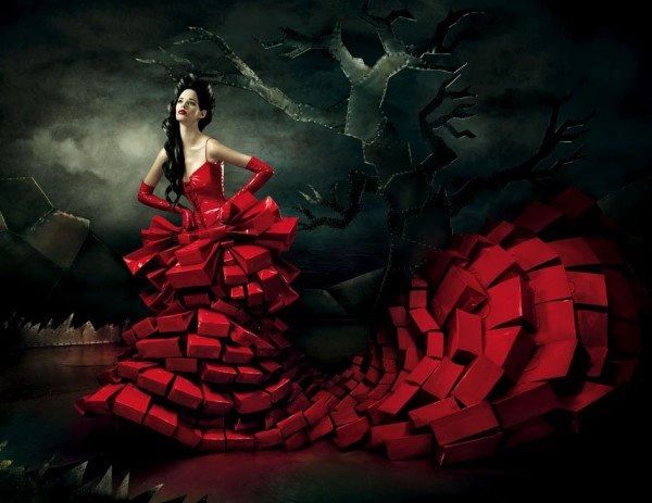 Woman in an elaborate red dress made of block shapes.