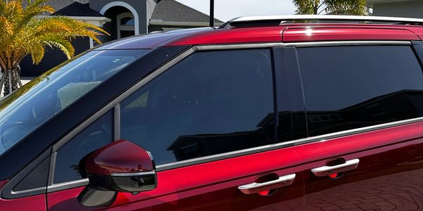 Red Kia Minivan with 35% ceramic window tints installed by our mobile tech in Melbourne FL