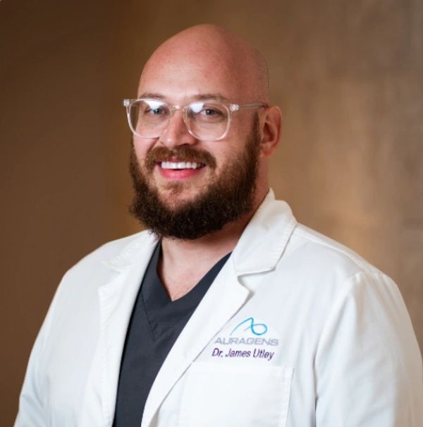 Smiling male doctor in glasses and white coat.