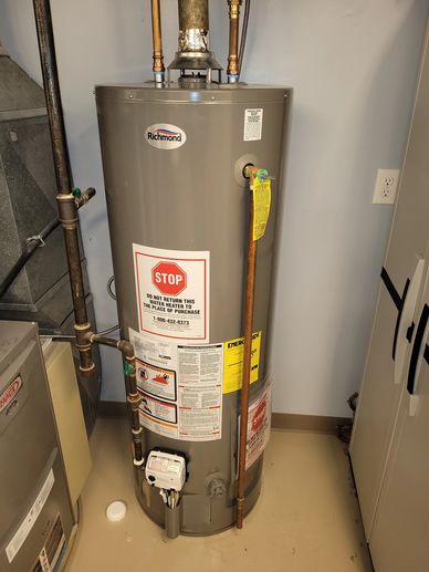 A Richmond water heater with safety and energy labels in a utility room.