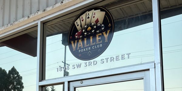 Entrance of Valley Poker Club with playing cards logo.