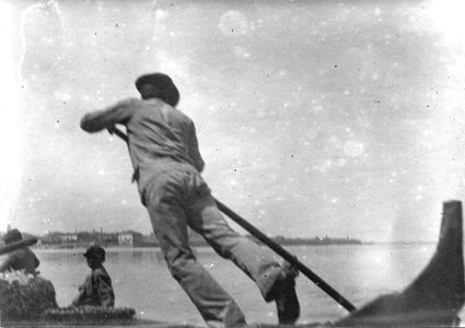 Gondolier in Venice, Italy, circa 1900