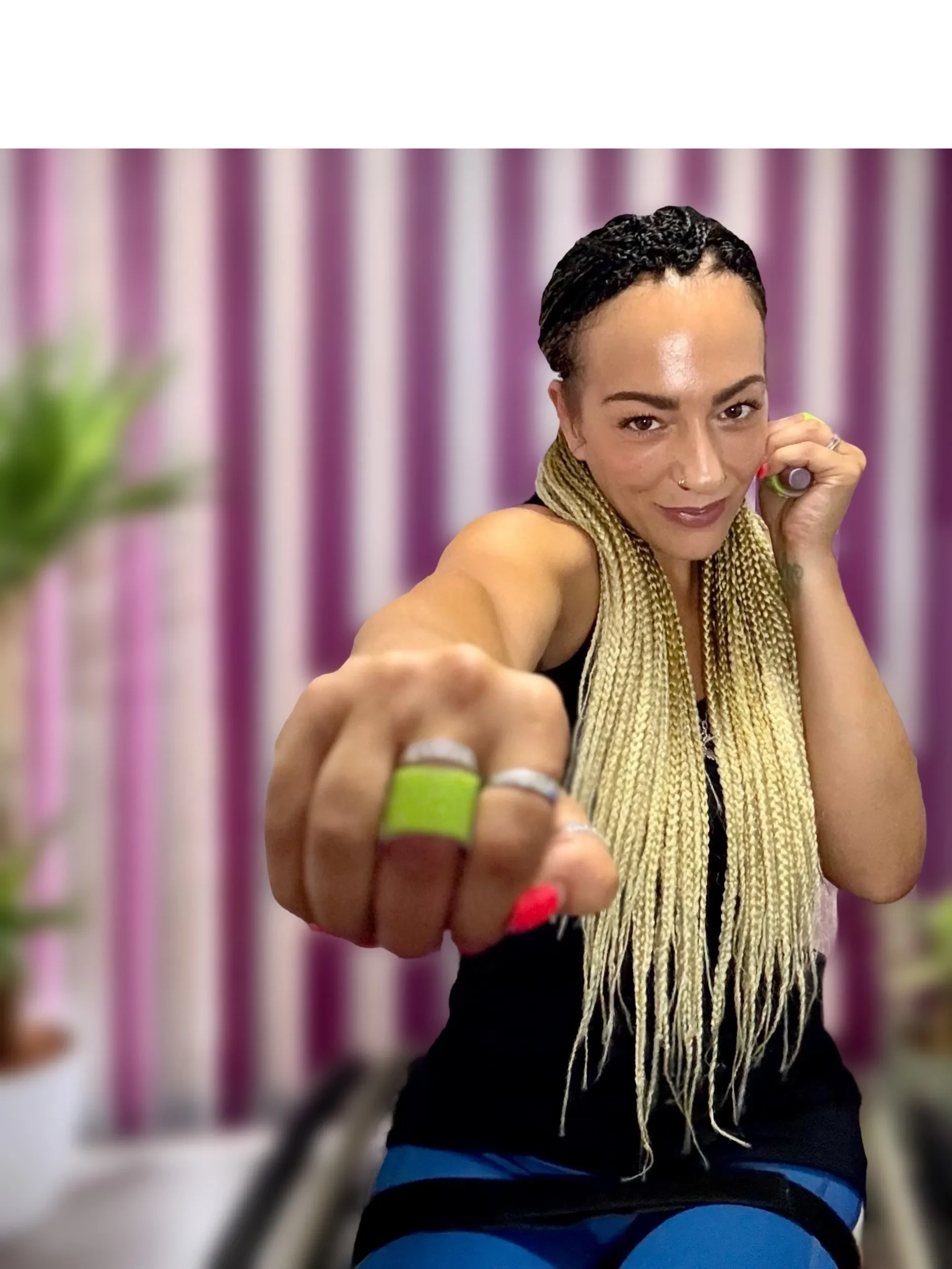Luiz Faye demonstrating a seated boxing punch from her wheelchair, 
