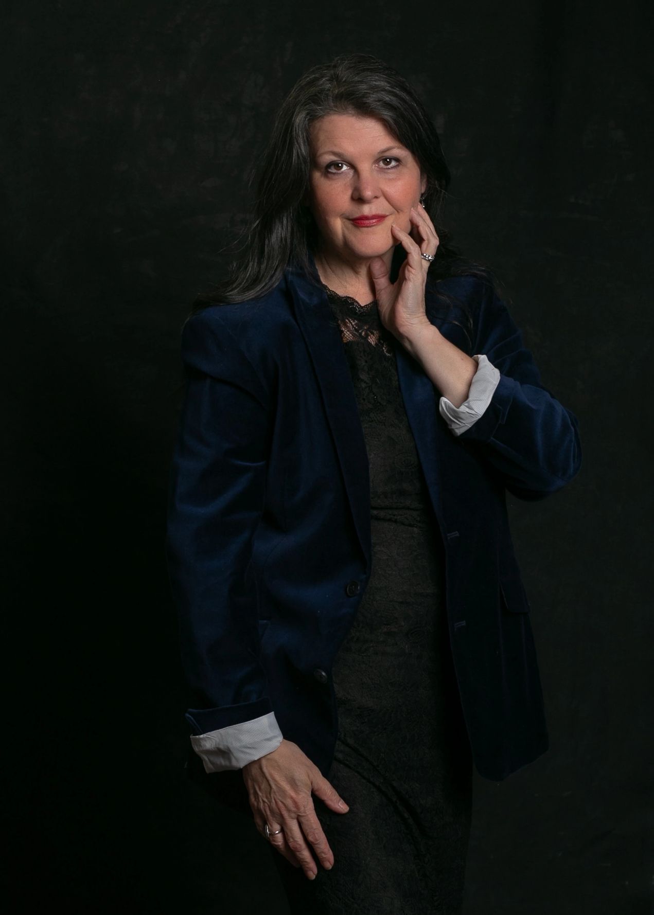 Self portrait of Christine in dark blue velvet jacket and lace dress.