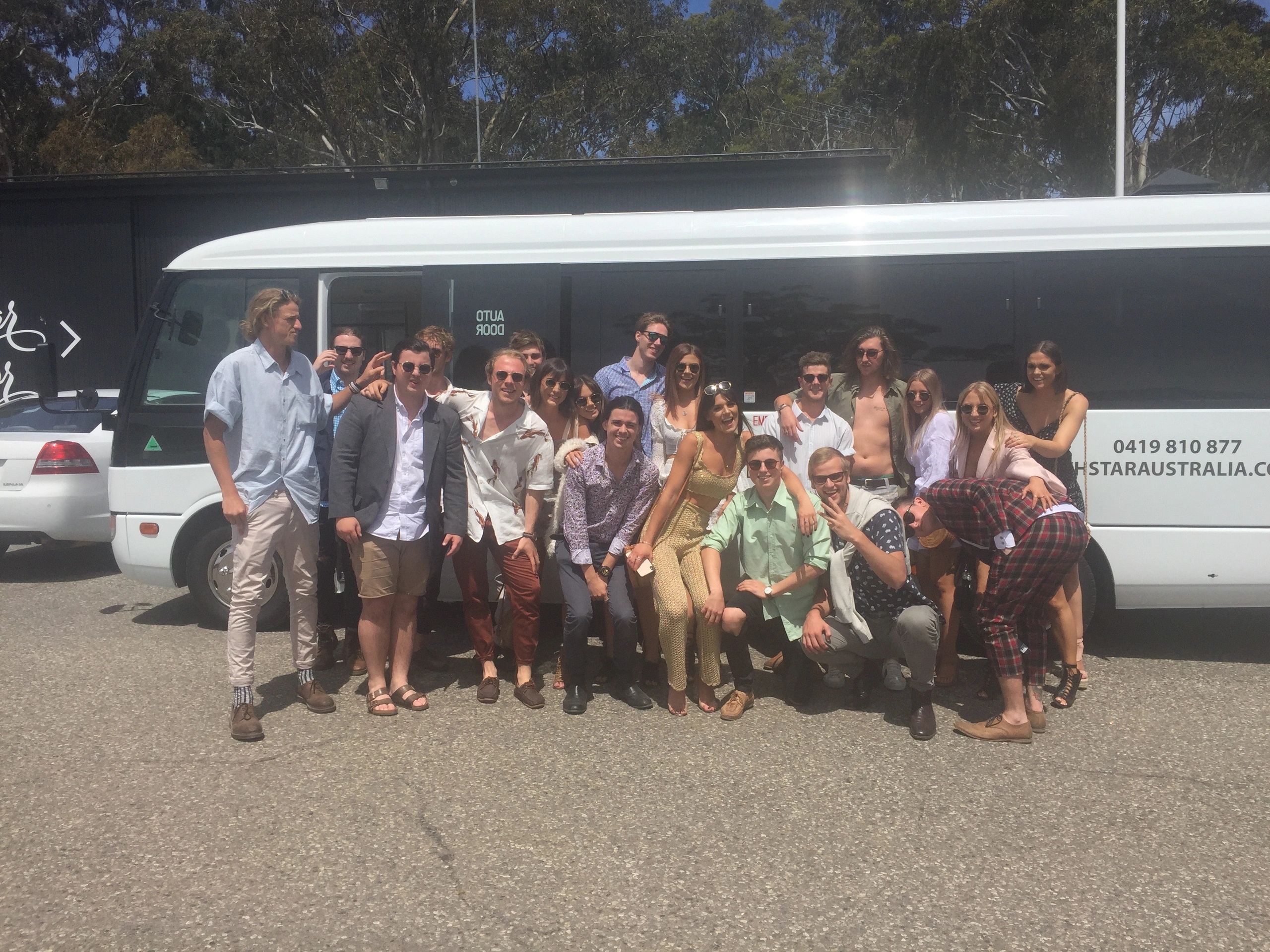 A Coachstar group gathered beside their coach on an outing