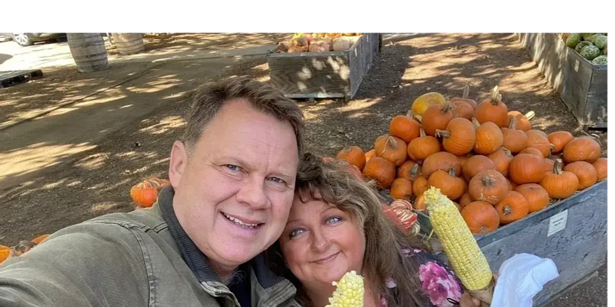 a man and woman clicking a selfie with corns 