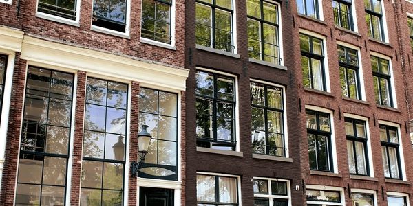 Shiny, clean, apartment windows viewed from the street in Amsterdam.