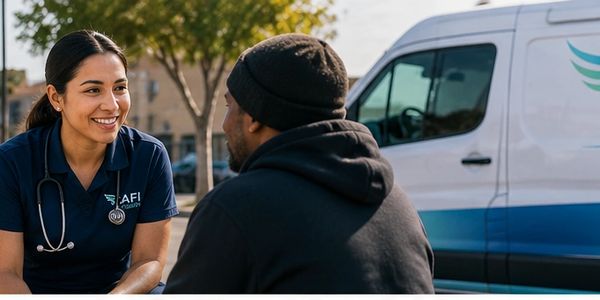 Healthcare worker talking to a man outdoors.