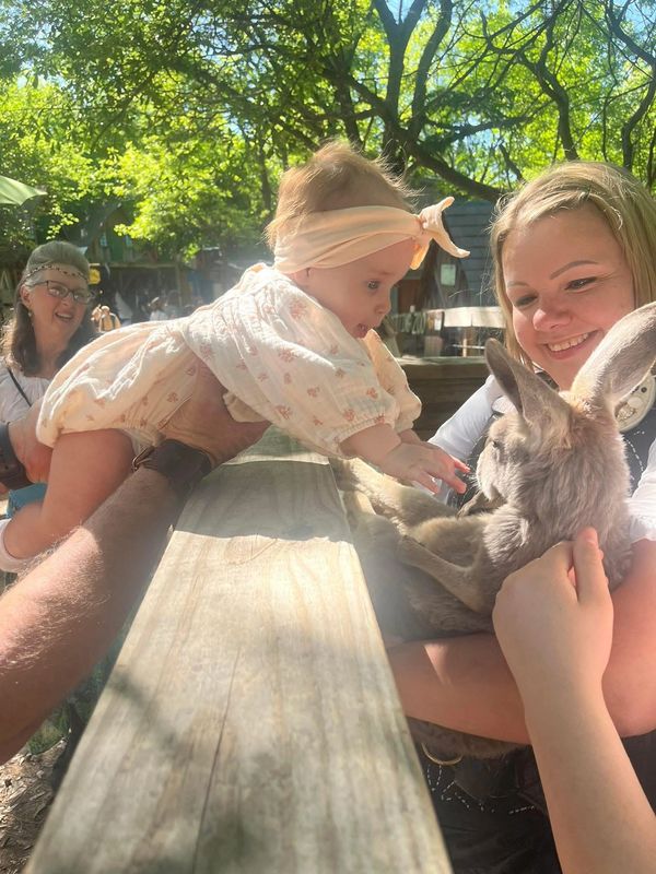 Baby petting the Royal Roo
