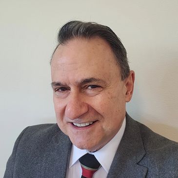 Smiling middle-aged man in a suit and tie.