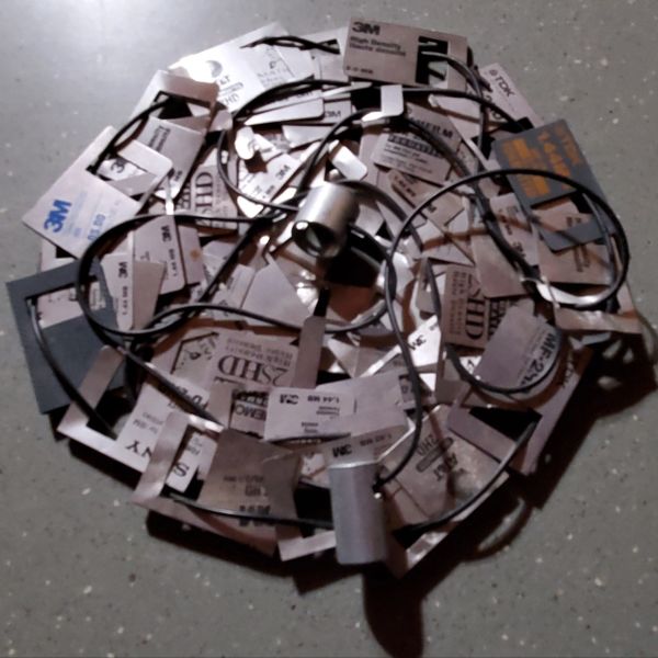 Circular arrangement of various 3M adhesive pads and wires on a surface.