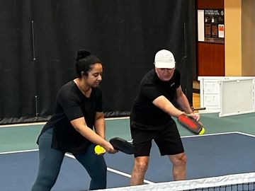 Andrew Gill, IPTPA certified instructor giving a student instruction on Pickleball shots and techniq