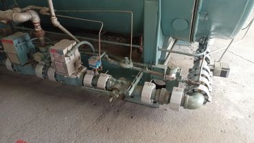 Industrial machinery with connected pipes and valves.