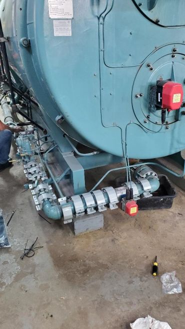 Industrial machine with pipes and control devices.