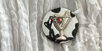 A metallic key keeper with a martini glass design