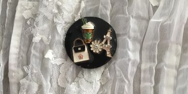 A key keeper designed with a coffee cup, Eiffel tower, white daisy, and a handbag