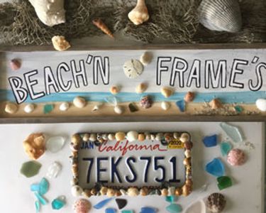 A license plate frame with seashells and sea glass