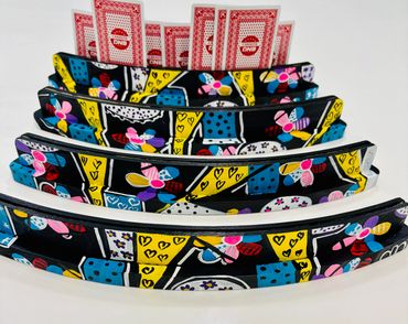 Colorful curved objects with playing cards.