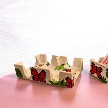 Hand-painted wooden card holders with butterfly and cactus designs.