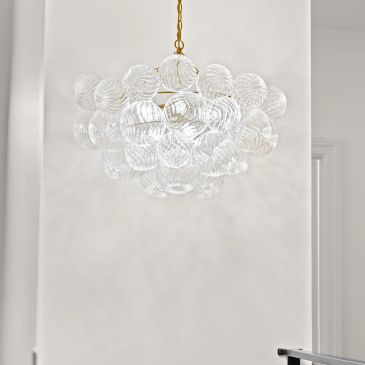 Elegant chandelier with glass bubbles and gold chain.
