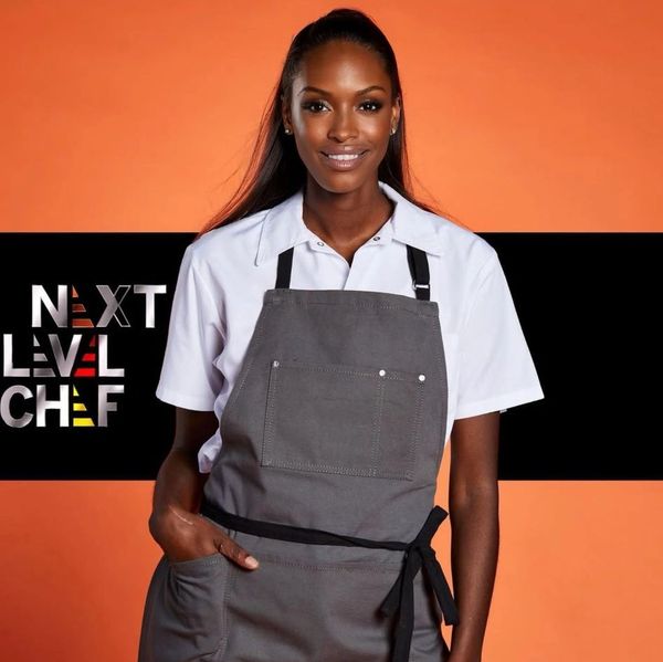 Confident chef posing in apron with Next Level Chef logo.