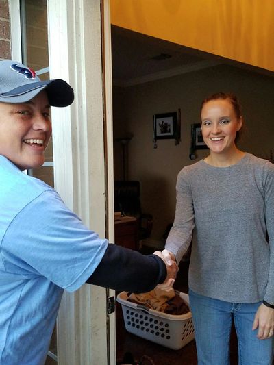 Sarah a master door refinisher greeting the homeowner