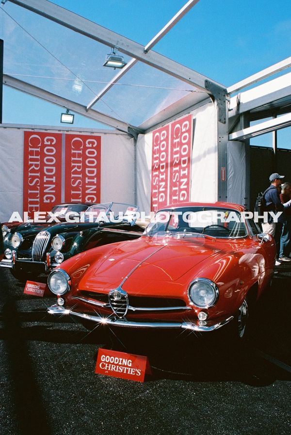Two classic cars displayed at Gooding &amp; Christie's auction tent.