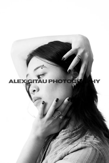 Black and white portrait of a woman with expressive hand poses.