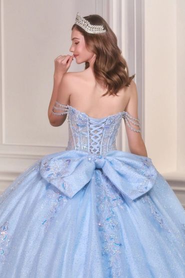 Woman in a sparkling blue ball gown and tiara.