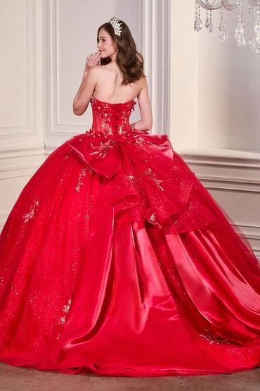 Woman in an elegant red ball gown with a tiara.