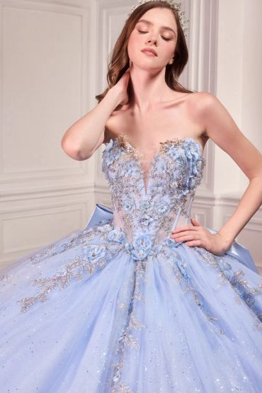 Woman in an elegant light blue floral ball gown.
