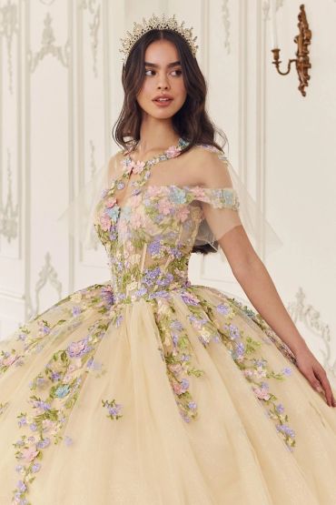 Woman in an elegant floral ball gown with a crown.