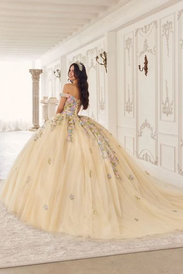 A woman in an elegant floral ball gown with a tiara.