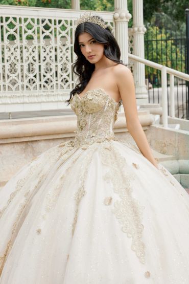 Young woman in a gold and white ball gown with a tiara.