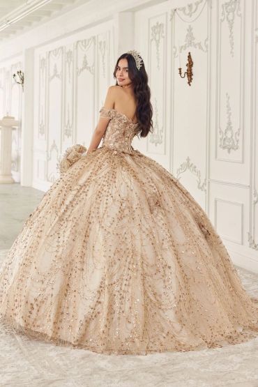 Woman in an elegant gold ball gown with a tiara.