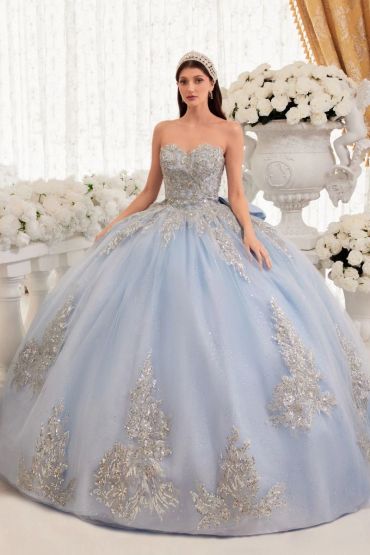 Woman in an elegant blue ball gown with silver embroidery.