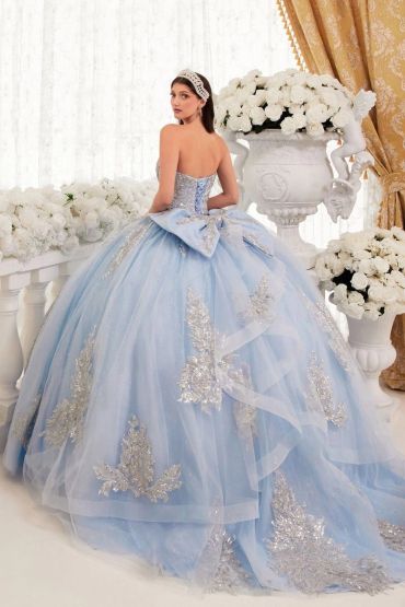 Woman in an elegant blue ball gown with silver details.