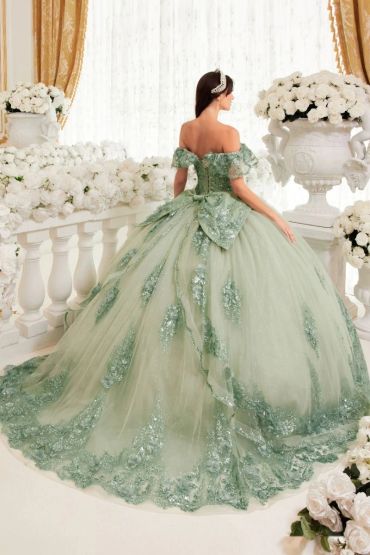 Woman in a green ball gown in a floral setting.