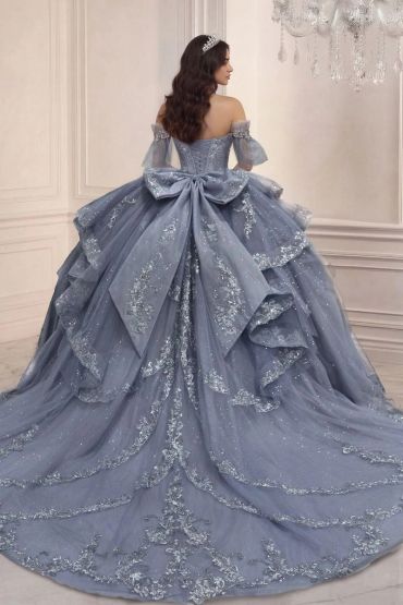 Elegant blue ball gown with glitter details and large bow.