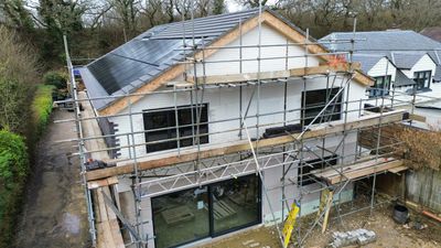 A house under construction with scaffolding around it.