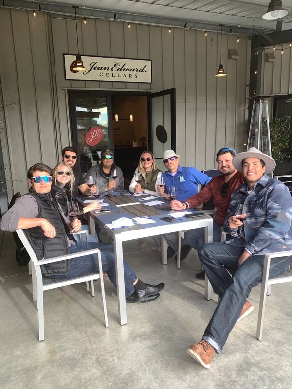 large group of customers enjoying a flight of wine on our outdoor patio.